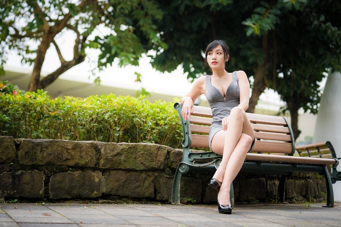 4K Asian Woman Sitting on Bench in Dress