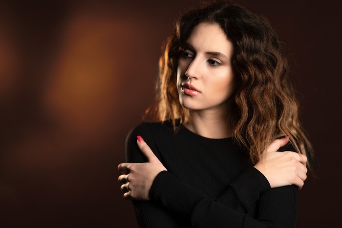 Chiara with brown wavy hair, posing
