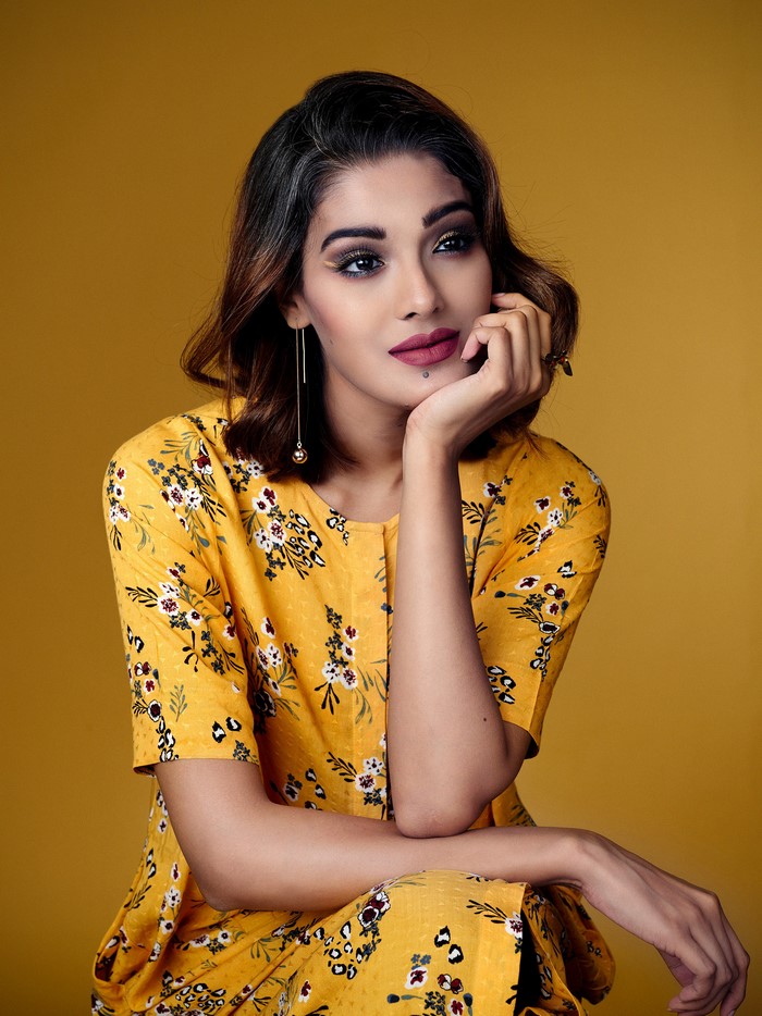 Woman with brown hair in yellow floral dress