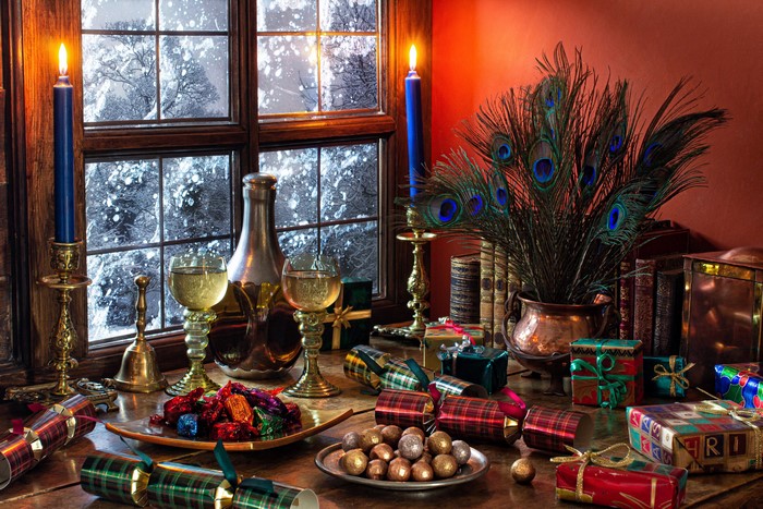 Christmas still-life with candles, champagne, and gifts