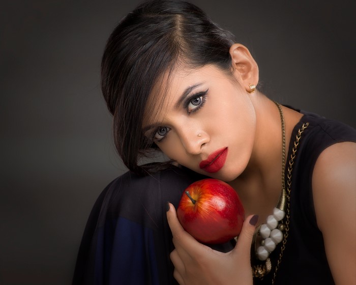 Woman with red apple and makeup