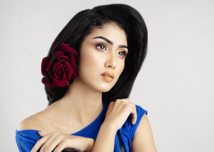 Brunette girl with rose and makeup