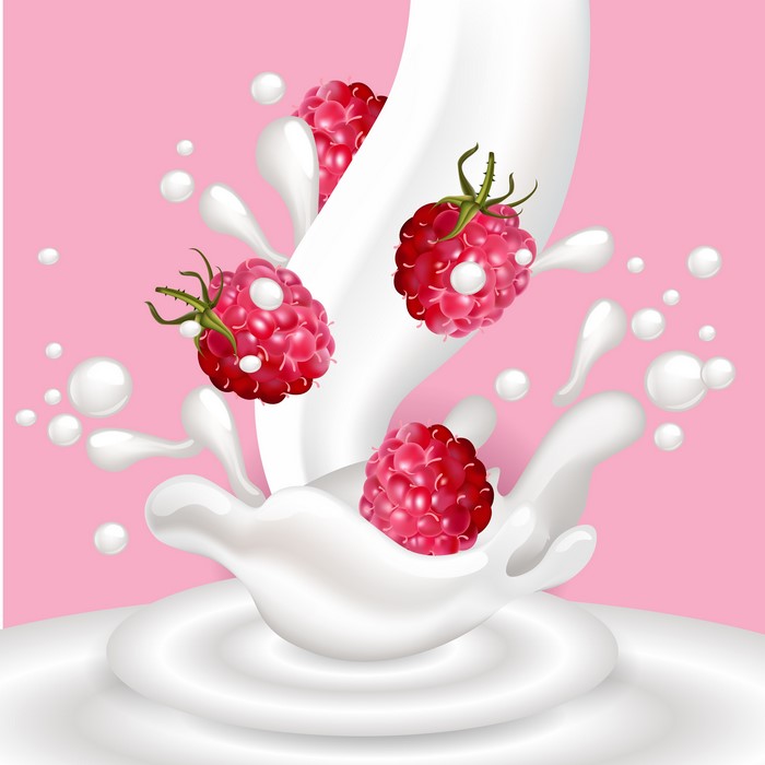 Raspberries splashing into milk