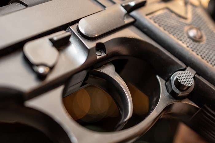 Macro closeup of a pistol trigger