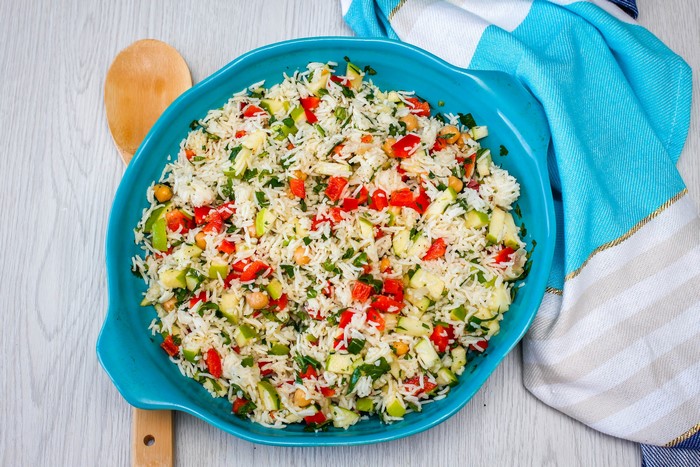 Rice salad with vegetables and chickpeas in a blue bowl