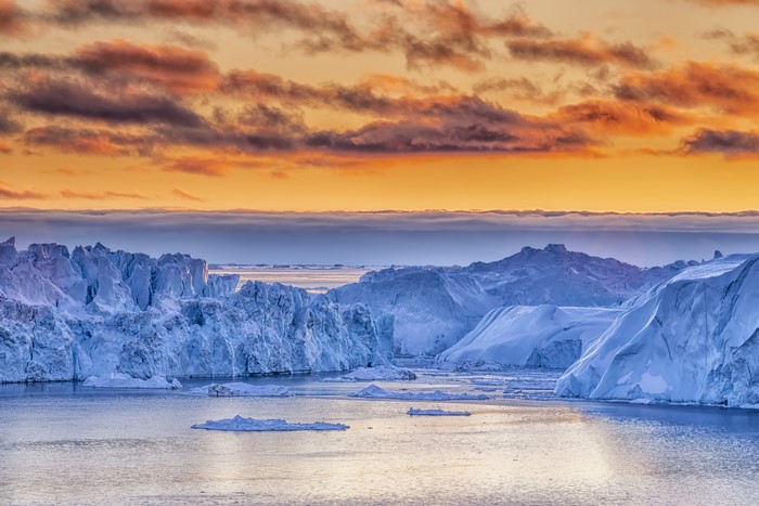 Serene Greenland Bay with Icebergs at Sunset