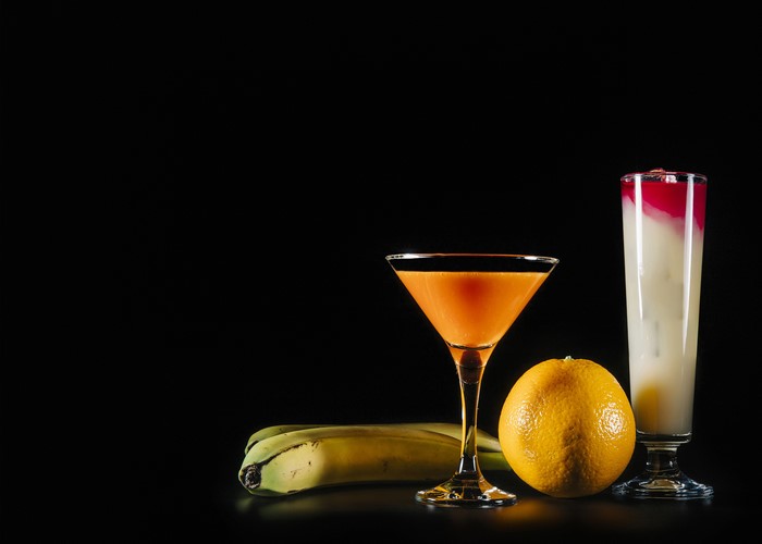 Cocktail with orange fruit and bananas