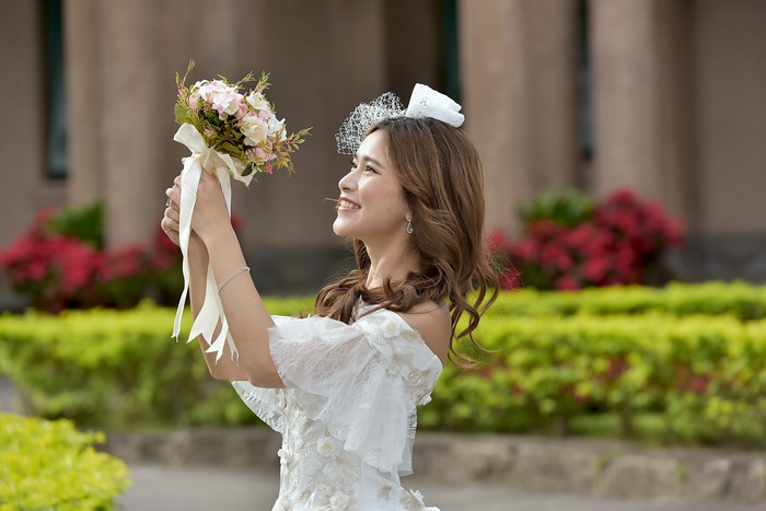 Bride Holding Bouquet with White Veil