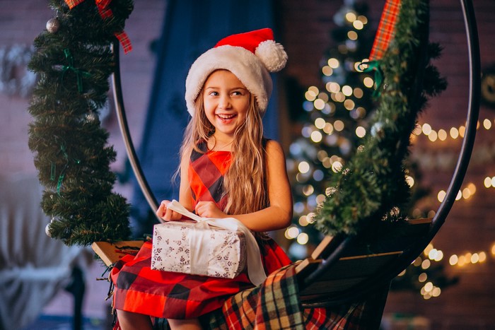 Girl in Santa hat with Christmas gift