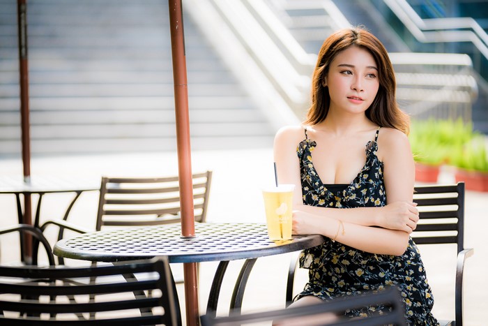 4K Asian Woman Sitting at Cafe Table