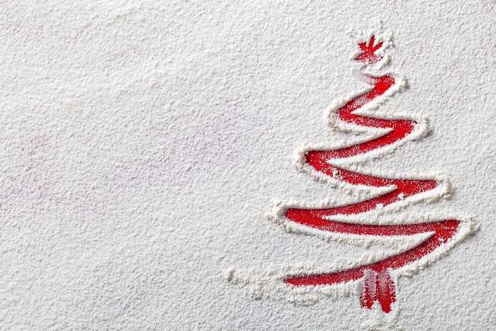 Christmas tree drawn in flour on red background