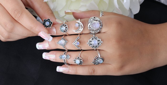 Many rings on fingers with manicure