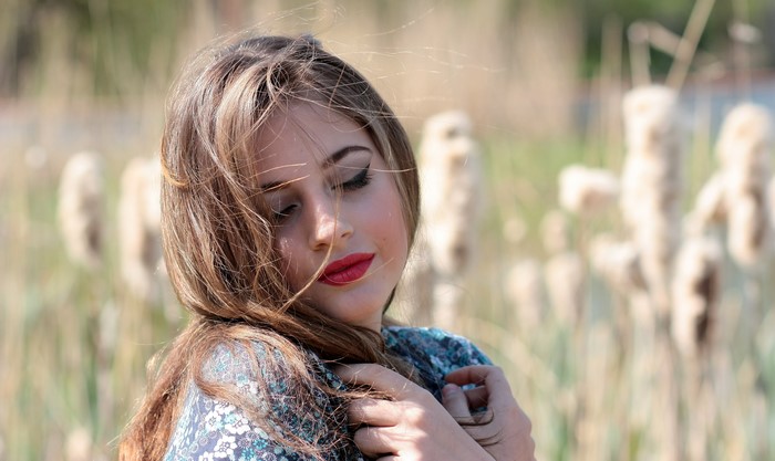 Beautiful woman with dark blonde hair and red lipstick