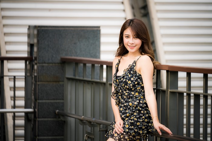 Asian woman with brown hair in a floral dress