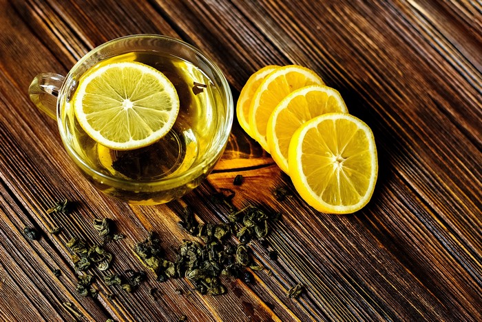 Tea with lemon slices and tea leaves