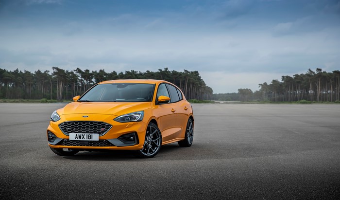 Orange Ford Focus ST on a road