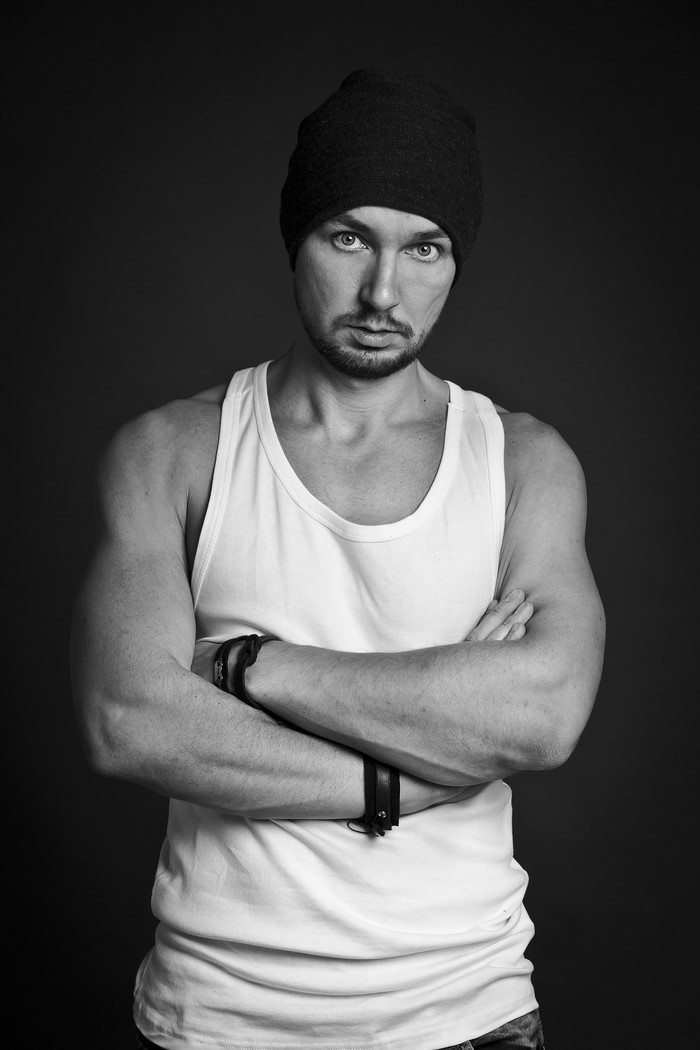 Man in singlet and beanie with arms crossed