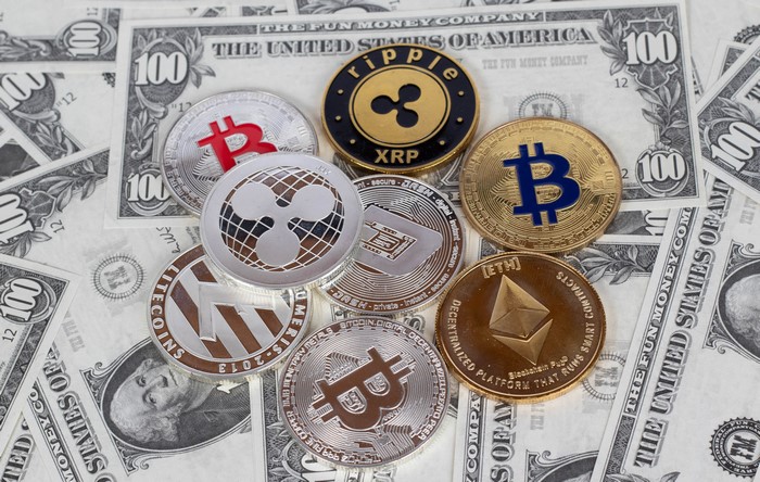 Cryptocurrency coins on US Dollar banknotes