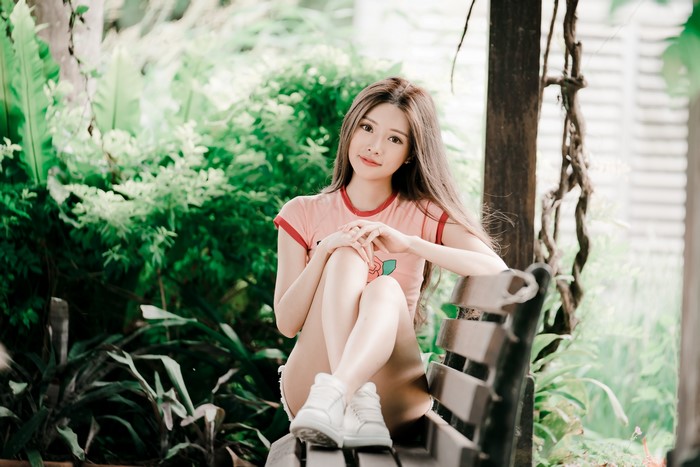 4K Asian Woman Sitting on Bench with Bokeh