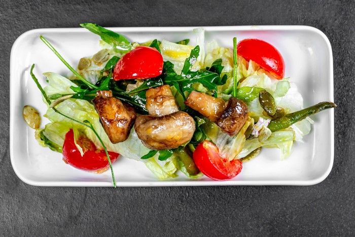 Salad with mushrooms, tomatoes, and greens