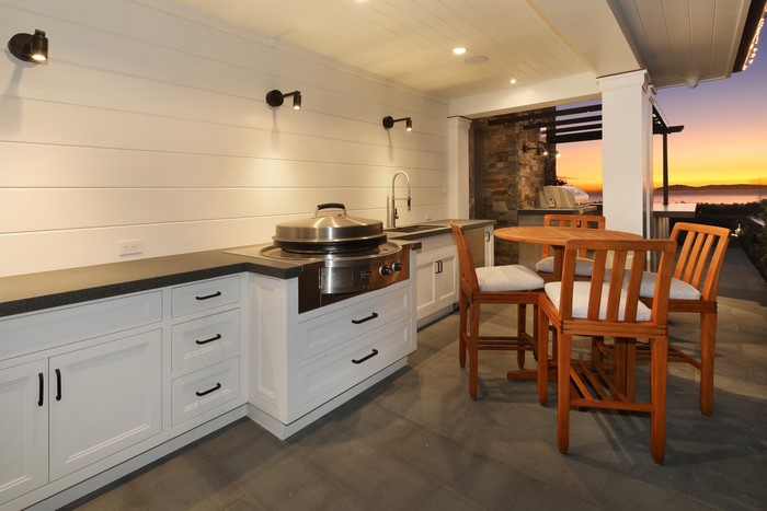 Outdoor Kitchen with Dining Set at Sunset
