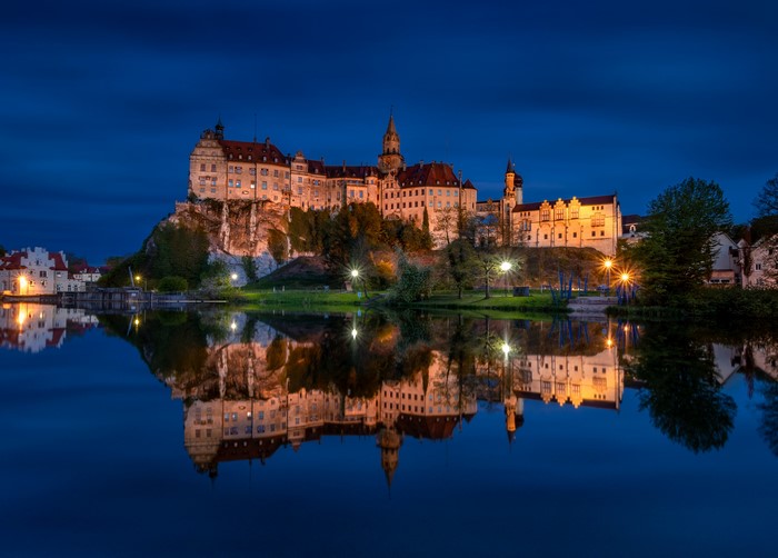 Sigmaringen Castle reflected in a river at dusk