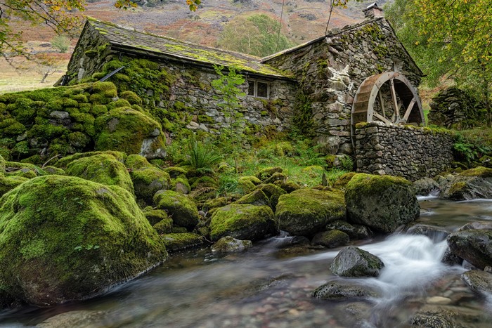 Moss-covered stone watermill in Borrowdale, England