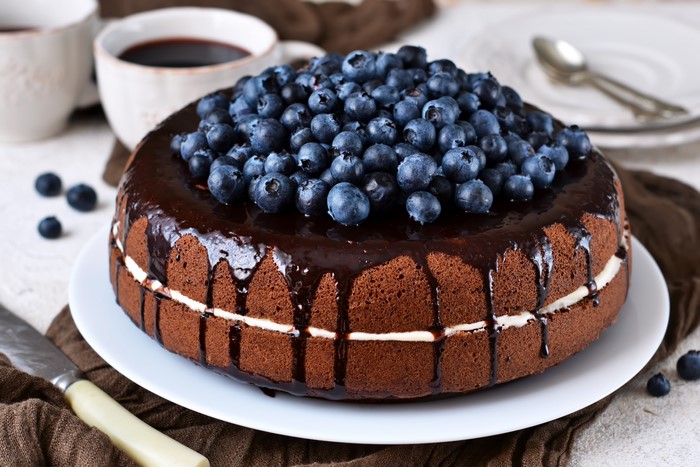 Chocolate cake with blueberries and cream