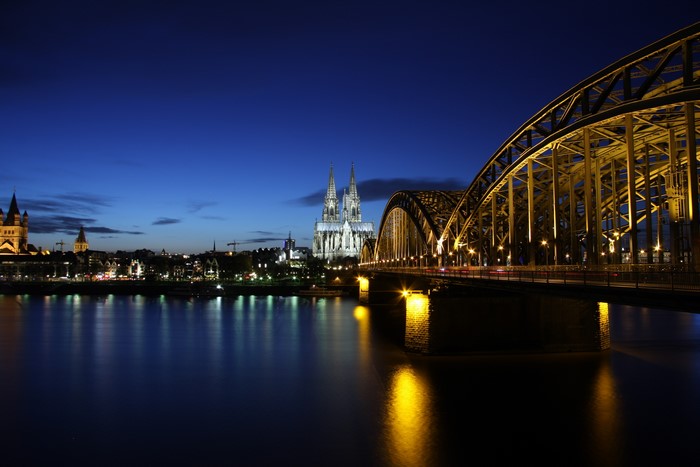 Cologne Cathedral and Hohenzollern Bridge over Rhine River at Night