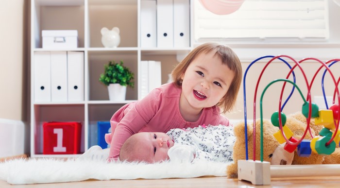 Two young girls playing with toys