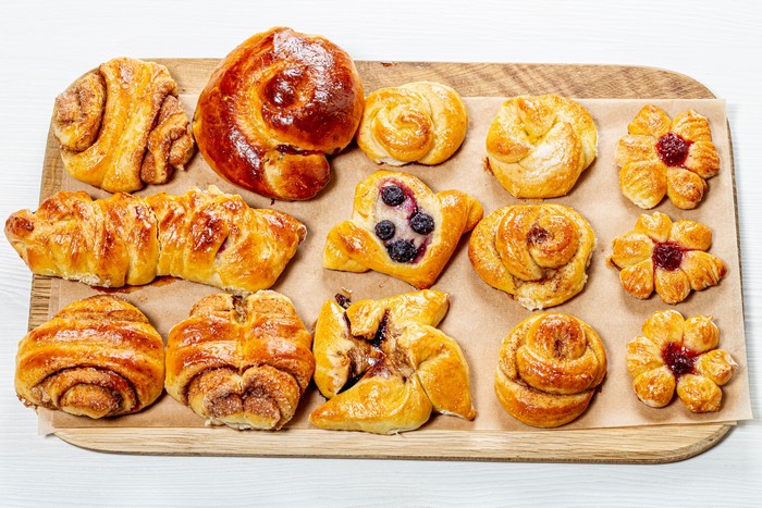 Assortment of Pastries and Buns on a Cutting Board