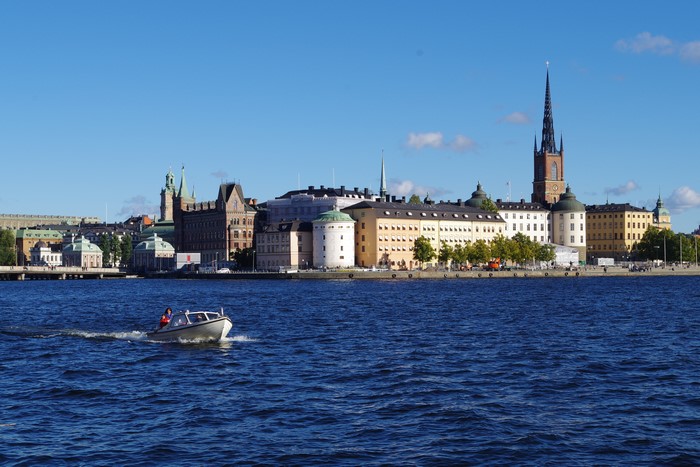 Motorboat on water with Stockholm cityscape