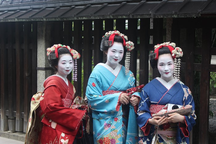 Three Geishas in Kimonos with Traditional Makeup