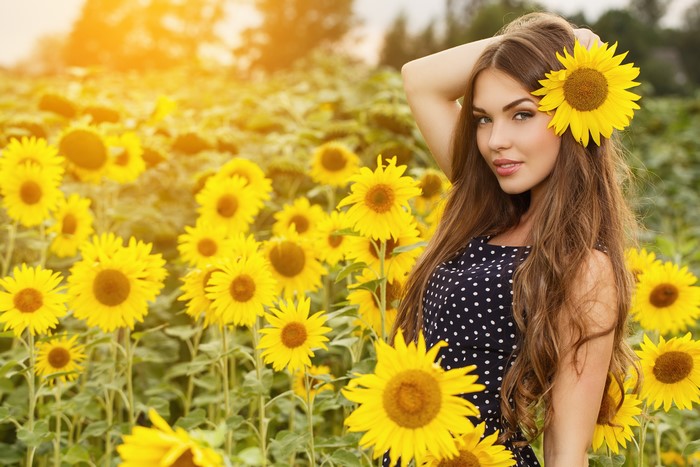 Woman with Sunflower in Sunflower Field