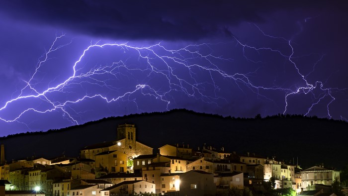 Lightning over a village at night