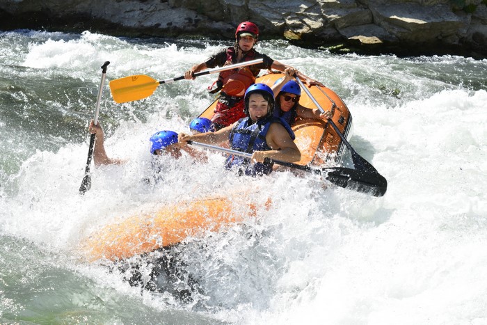 People Rafting Down a River