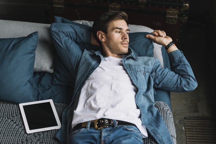 Man in Denim Jacket and Jeans with Tablet