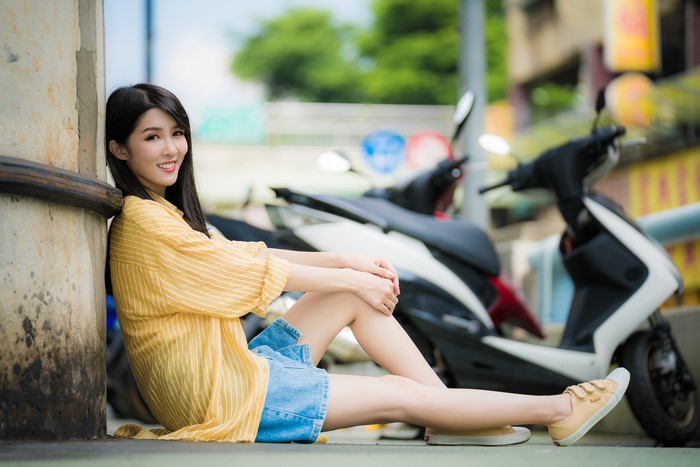 4K Asian Woman Sitting and Smiling Outdoors