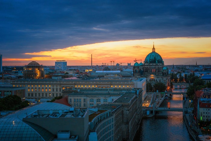 Berlin cityscape with river and cathedral at sunset