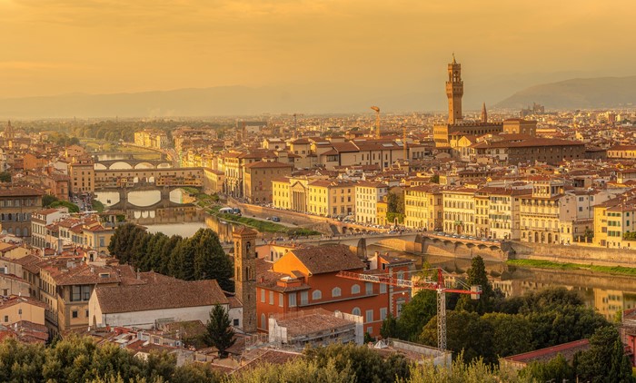 Florence cityscape with Ponte Vecchio and Arno River at sunset