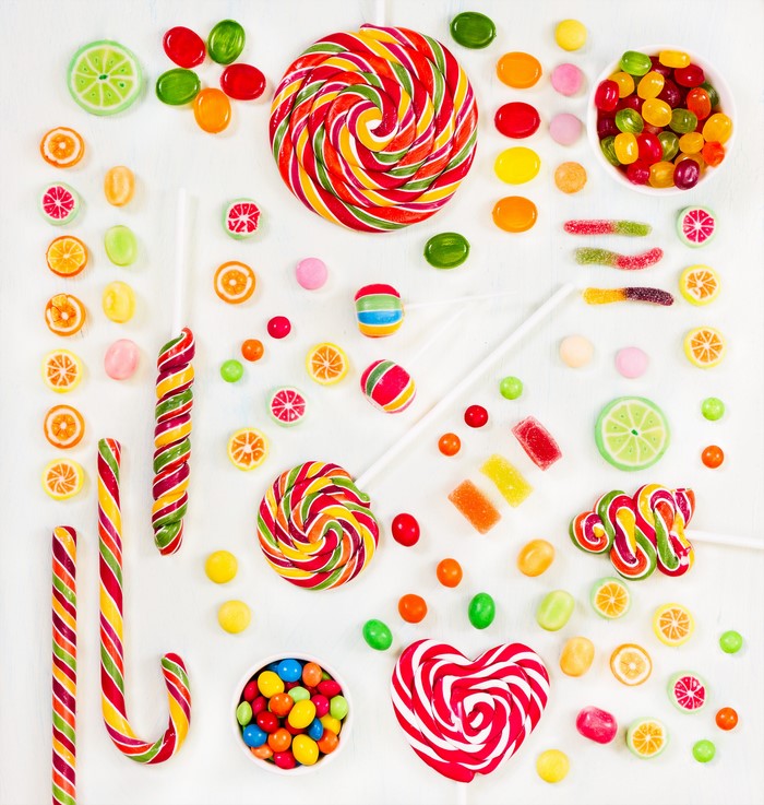 Assortment of colorful candies and lollipops on a white background
