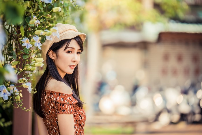Asian girl with flowers and hat