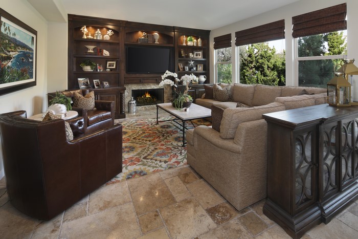 Living room with fireplace, sofa, and armchair