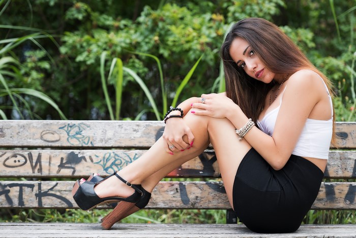 Carlotta sitting on a graffiti bench