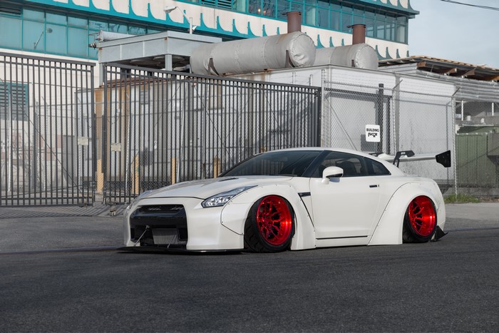 White Nissan GTR with red wheels