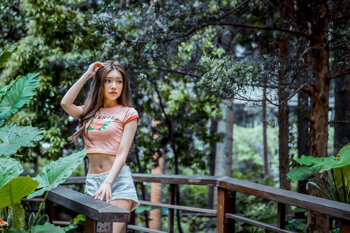 Asian woman with brown hair wearing a t-shirt and shorts