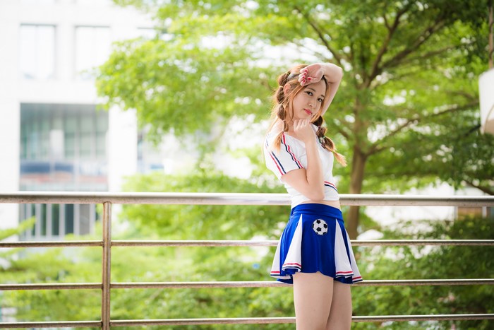 Asian girl in cheerleader outfit with braid hair