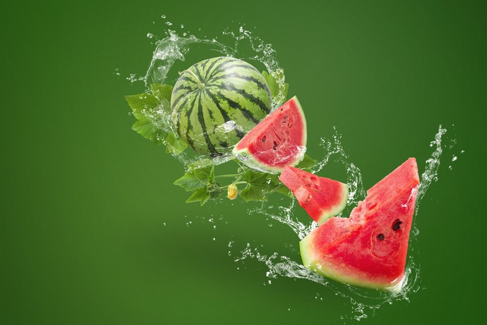 Watermelon slices and whole watermelon with water splash