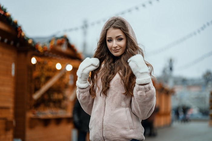 Woman in jacket and mittens at market