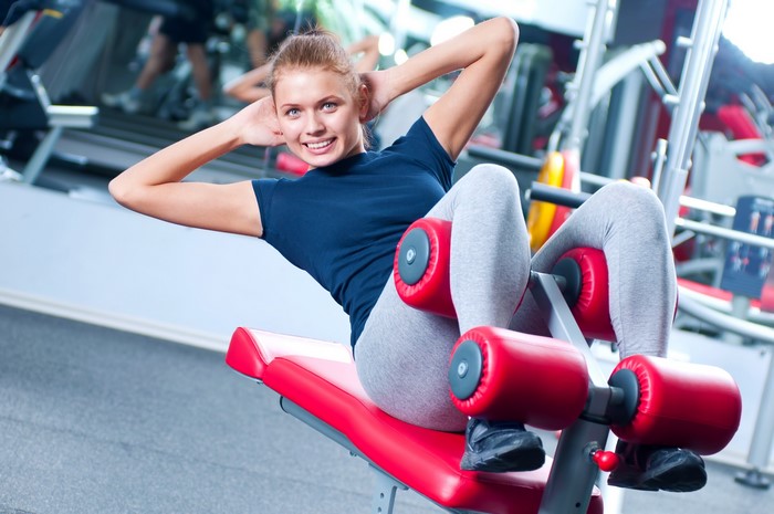 Woman doing sit-ups on a workout machine